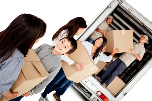 Removal van and moving team in a Brent residential street