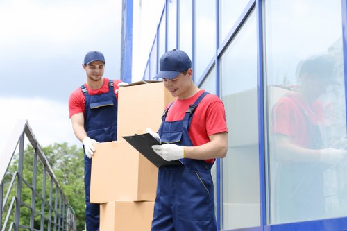 Removal team preparing furniture with safety focus