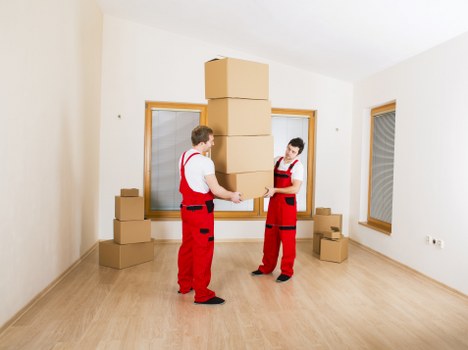 Packed moving boxes and furniture ready for removals in Brent