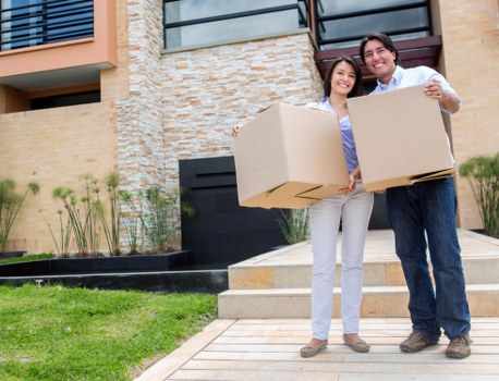 Packed boxes and furniture being loaded into a moving van